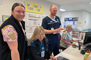 Four nurses at the Barker Ward nurses station at Peel Health Campus
