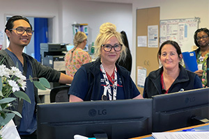 Two male and two female nurses working at the Cove Ward nurses' station at Peel Health Campus