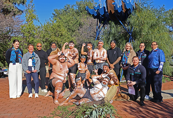 A large group of Peel Health Campus staff and the Bibbulmun Koordas dance group.